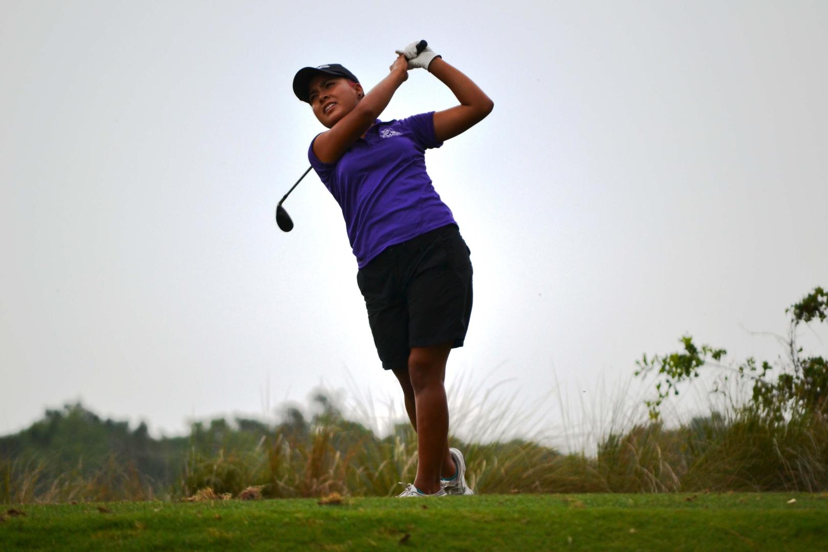 Students playing golf