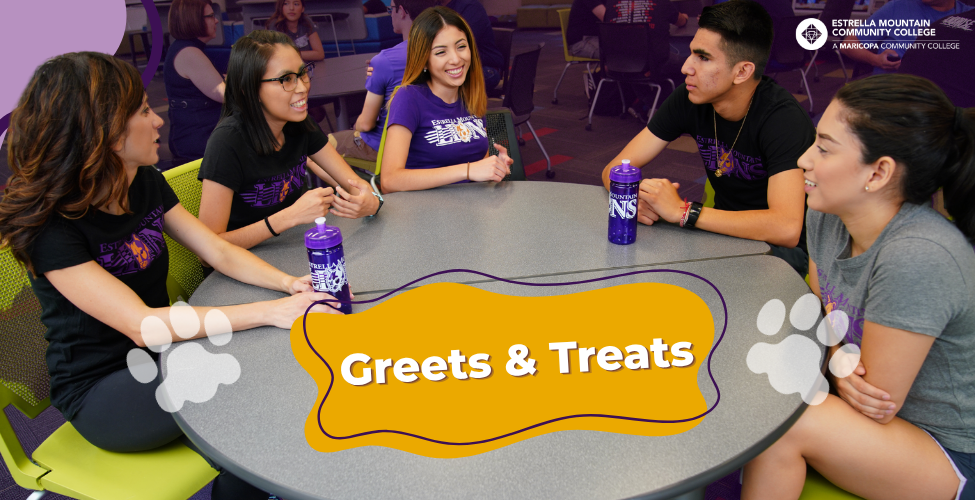 Students sitting a table talking.
