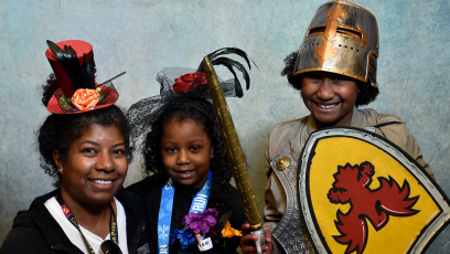A mother and her two children smiling.