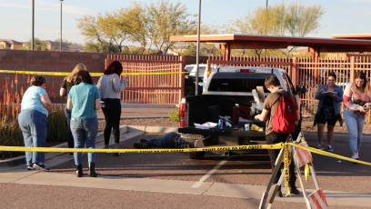 Students in parking lot navigating the mock crime scene.