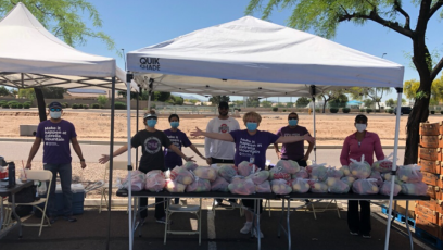 EMMC staff with outside tent or canopies servicing food from  St. Mary’s Food Bank.