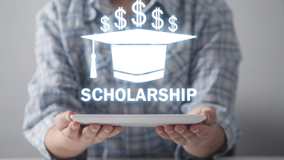 person holding graduation cap drawing that says scholarships