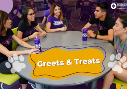 Students sitting a table talking.