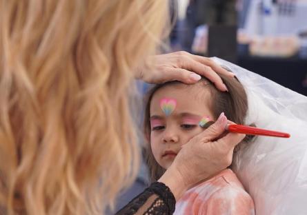 Desert West Market attendee getting their face painted