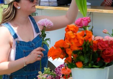 Desert West Market attendee examining tulips
