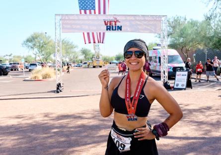 Runner displays their completion medal