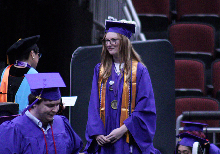 Madalynn Eidson walking on stage during graduation.