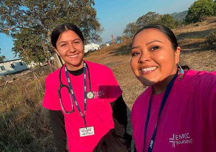 Alysha and Victoria outside working.