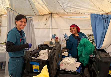 Alysha and Victoria inside the tent working.