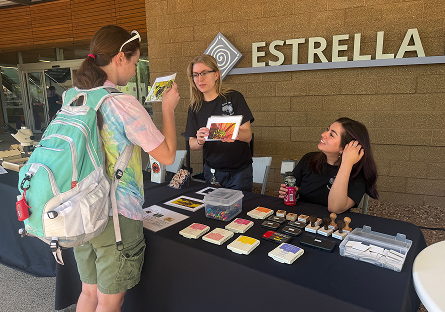 Earth forward table booth set up outside of Estrella Hall.