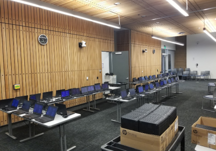 ""Rows of laptops on tables in computer lab.