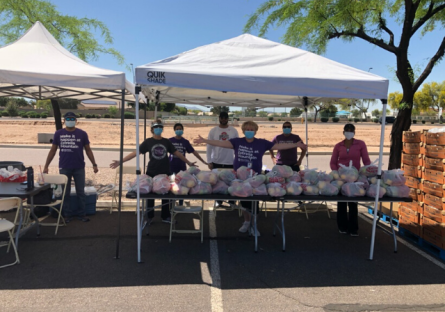 EMMC staff with outside tent or canopies servicing food from  St. Mary’s Food Bank.