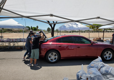 EMMC staff loading food into student's cars.