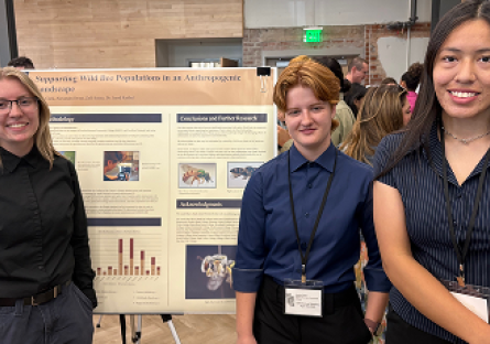 Alex, Arella, and Zalli standing near project poster board.