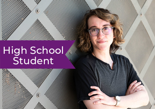 A high school student leaning against the wall on EMMC campus.