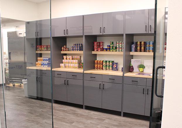 Interior of Food Pantry showing shelves and cabinets filled with food.