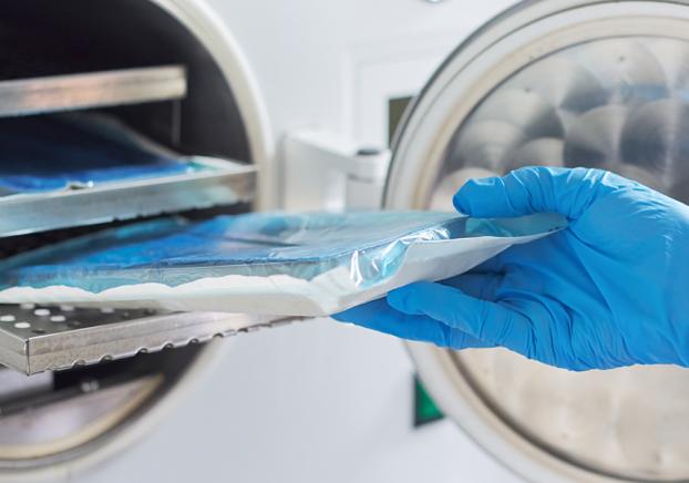 gloved hand handling medical sample