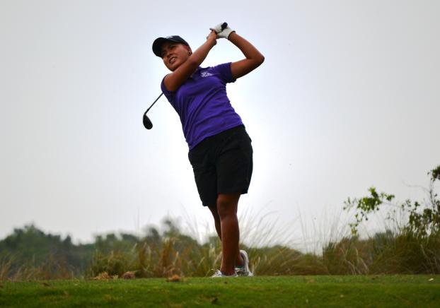 Woman playing golf.